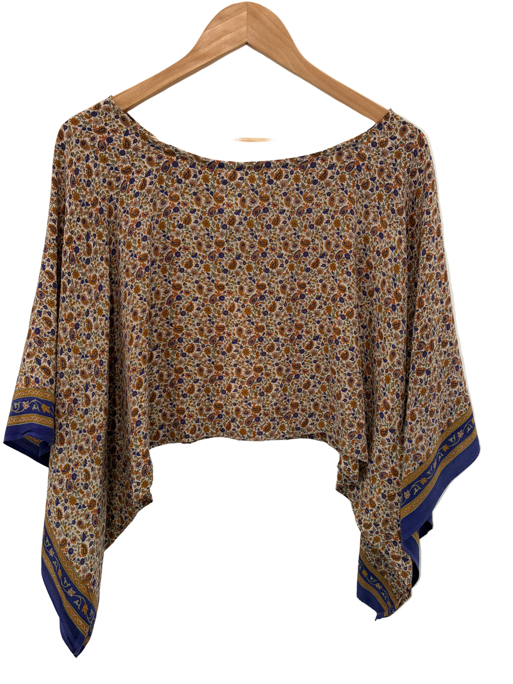 Floral-patterned shirt on a hanger against a white background